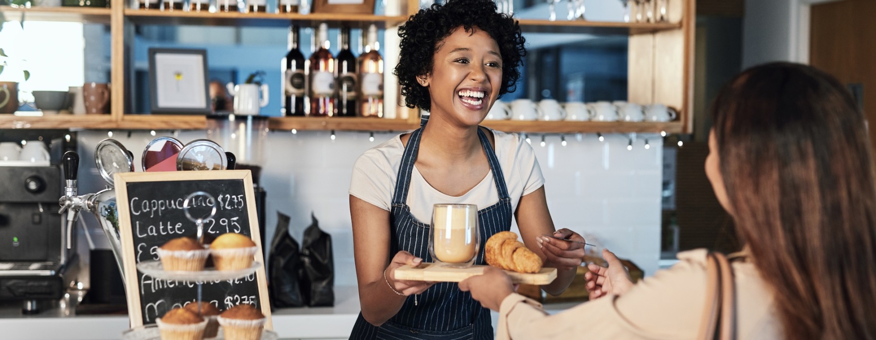 woman getting food and coffee at a coffee bar